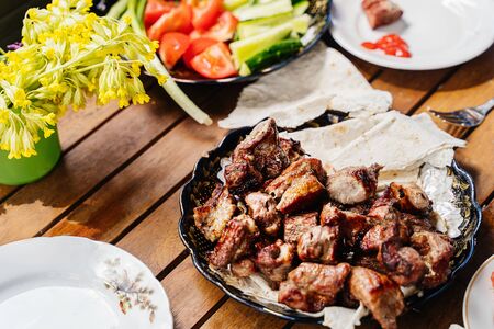 cooked pork neck kebabs on skewers on a platter. Traditional dishの写真素材