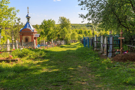 A small brick chapel in the cemetery, sunny summer day, horizontal frame