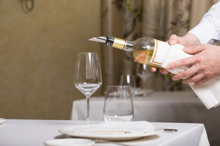 Empty glasses and plates installed in the restaurant, the restaurant served table, white tablecloth and wineの写真素材