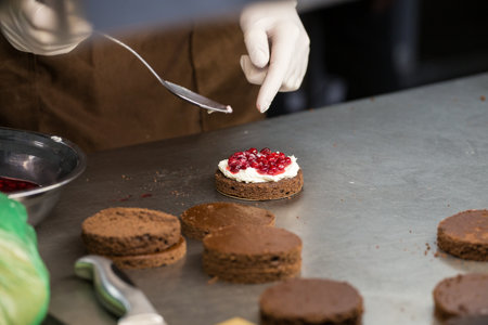 preparation of cakes with cream and berries,