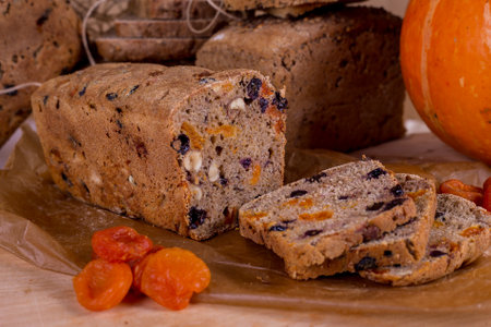 a loaf of bread on the background of cutting boards and other bread and pumpkin,