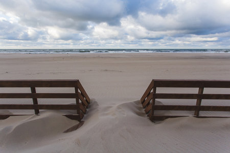 wooden fence in the sand on the beachの写真素材