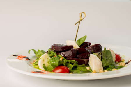 vegetable salad with beets on a plate on a white backgroundの写真素材