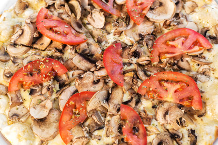 vegetarian pizza with champignons and tomatoesの写真素材