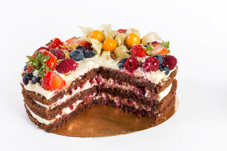 cake with fresh berries on white background