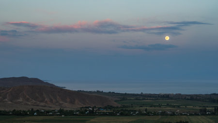 Moonrise over the lake Issyk Cul