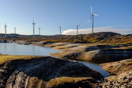 wind farm beyond the Arctic Circle, windmills on a lake among the rocks in norway