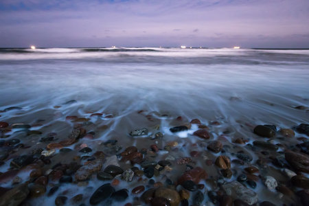 sea surf, pebbles, clear night during a full moon, the Baltic Seaの写真素材