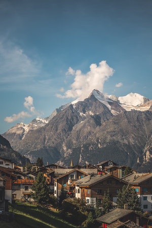 view of a village in switzerland, sunny landscape in the mountainsの写真素材