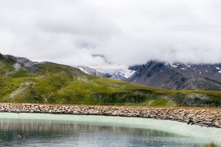 artificial lake high in the mountains in switzerlandの写真素材