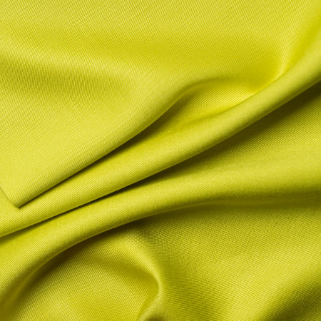 Texture, background. Yellow silk fabric. Abstract background of luxury cloth or liquid wave or wavy grunge silk texture.の写真素材