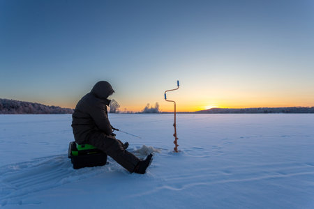 winter fishing in the north, frost at sunsetの写真素材