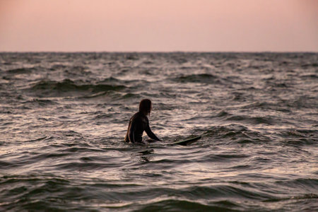 surfer waiting for a wave on a board in the Baltic Sea