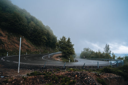 Good asphalt road in the mountains, serpentine turn in the clouds