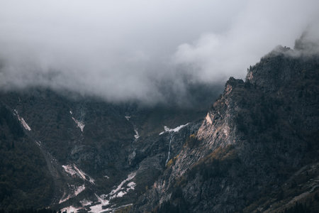 Mountains in the clouds, waterfall in the harsh mountains of Georgiaの写真素材