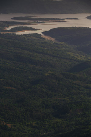 bird's eye view of mountain lake at sunset, winding lake among mountains