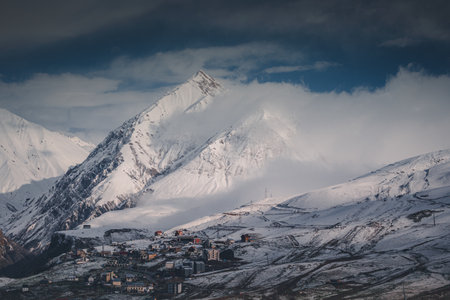 Gudauri village in Georgia in spring, mountains covered with snow