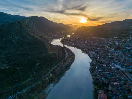 view of the city on a sunset, aerial view, flying straight