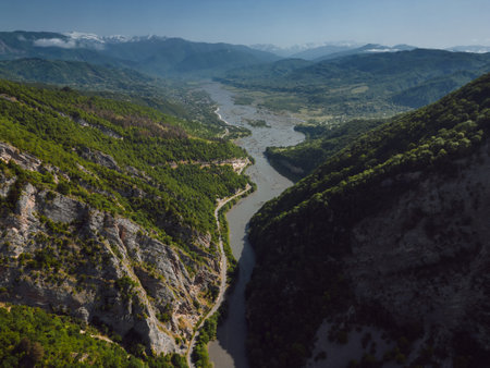 drone flight over a green gorge with mountains, road to the gorge, aerial view