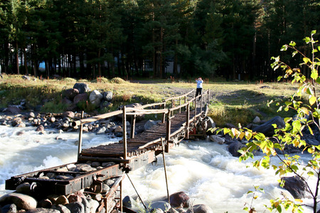Bridge through the mountain small river, Tracking to Prielbrusye, the Caucasus, Russiaのeditorial素材