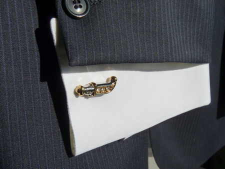 Cuff link for a cuff on a shirt in the form of an ancient knife