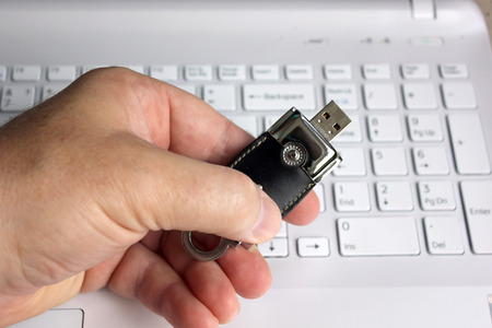 Elite store of memory in leather cover on the laptop keyboard