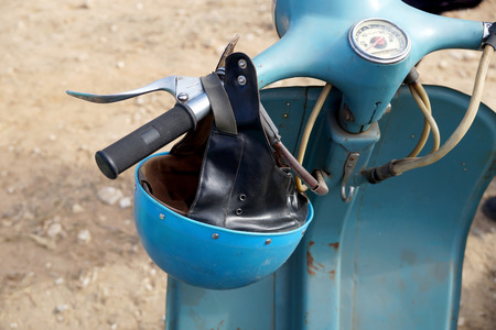 An old plastic helmet on a retro a motor scooterの写真素材
