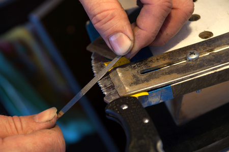 Sharpening of a knife with the serreytors cutting edgeの写真素材