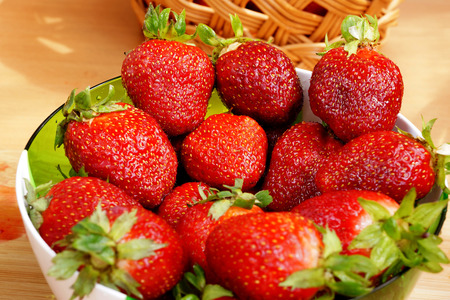 Bright fresh strawberry on a table in a round containerの写真素材