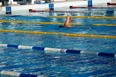 Swimmer in the big outdoor swimming poolの写真素材