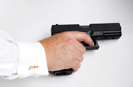 The businessman with the gun, as allegory of rigid competitiveness