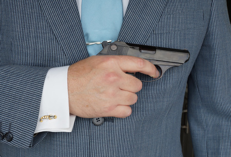 The businessman with the gun, as allegory of rigid competitivenessの写真素材