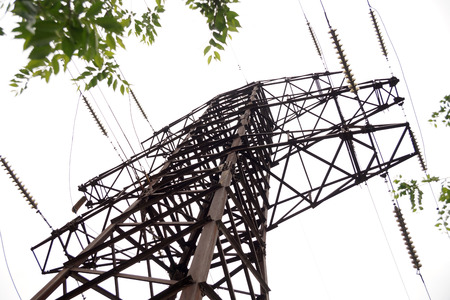 Old rusty mast of power lines on the city streetの写真素材