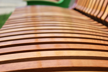 Wooden laths on a seat mat and on a back of a city shopの写真素材