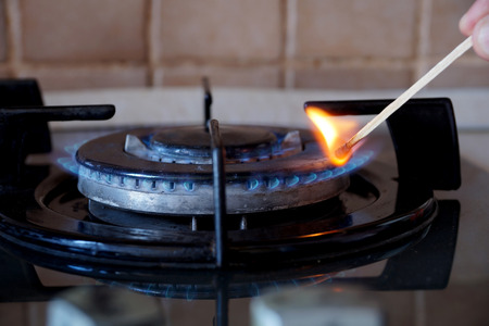 Ignition by a match of a gas ring on the stoveの写真素材