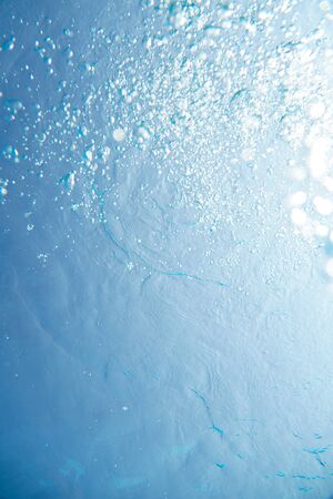 Rising bubbles in water of the swimming poolの写真素材