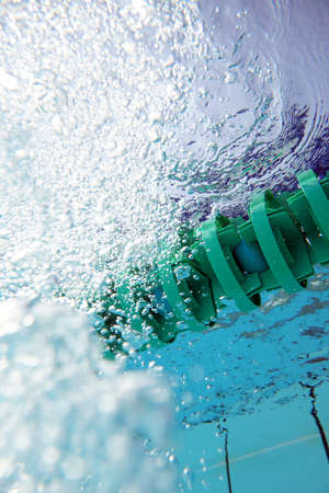 Rising bubbles in water of the swimming pool