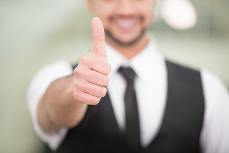 Happy young Indian businessman with thumb up.の写真素材