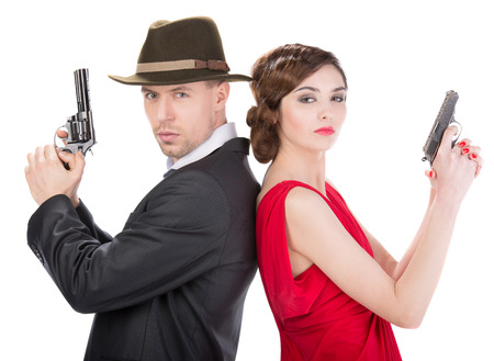 Man gangster and sexy spy woman with guns. Isolated on white backgroundの写真素材