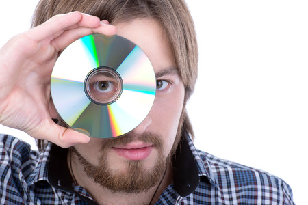 Portrait of a handsome young man holding cd against a white backgroundの写真素材