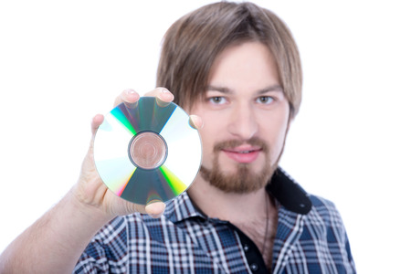 Portrait of a handsome young man holding cd against a white backgroundの写真素材
