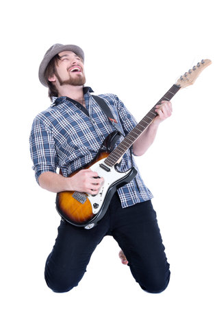 Young guitarist plays on the electric guitar, isolated on white backgroundの写真素材