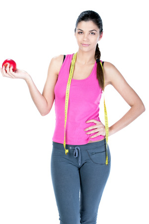 Healthy diet eating woman with scale and apple for weightloss isolated on white の写真素材
