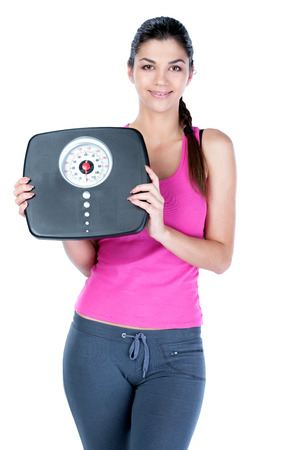 Healthy diet eating woman with scale and apple for weightloss isolated on white の写真素材
