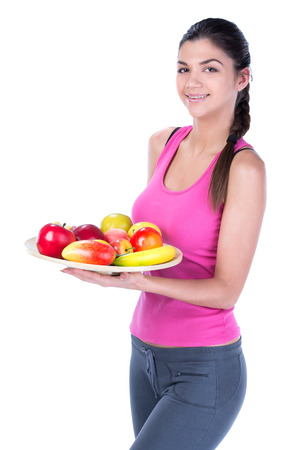 Beautiful fitness young woman with fruits. Isolated on white .の写真素材