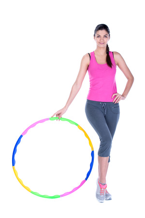Young woman doing exercises with hoop. Isolated on white .の写真素材