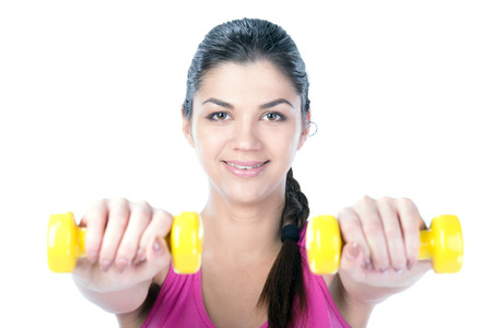 Fitness woman working out with dumbbells. Isolated on white .の写真素材