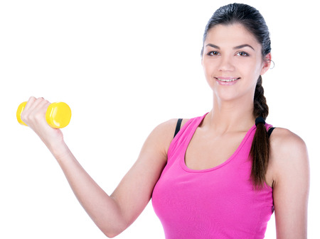 Fitness woman working out with dumbbells. Isolated on white .の写真素材