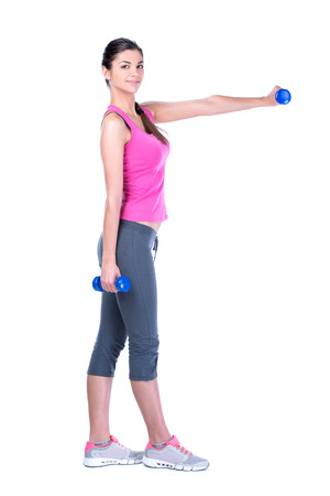 Fitness woman working out with dumbbells. Isolated on white background.の写真素材