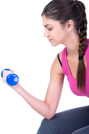 Fitness woman working out with dumbbells. Isolated on white .の写真素材